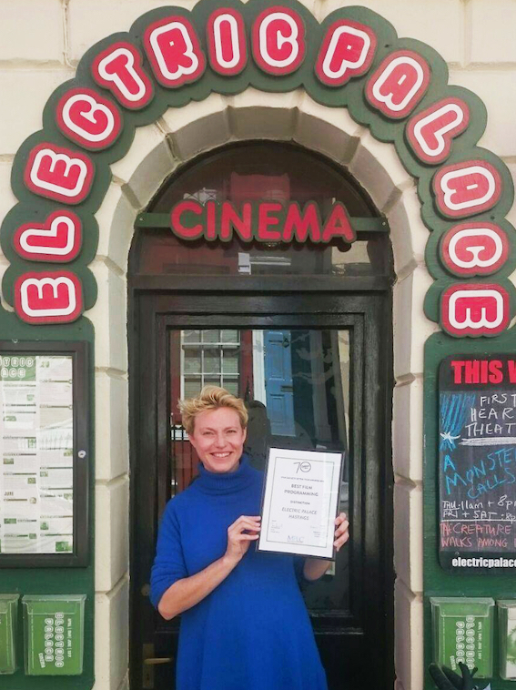 Rebecca Marshall outside the Electric Palace cinema holding a placard